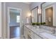 Bathroom boasting double sinks, granite countertops, and a view to an adjacent room at 1009 Margarets Ln, Raleigh, NC 27614