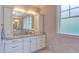 Bright bathroom featuring a white vanity with granite countertops, marble flooring, and decorative lighting at 1009 Margarets Ln, Raleigh, NC 27614