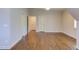 Spacious bedroom featuring hardwood floors, a large window, and access to two additional rooms at 1009 Margarets Ln, Raleigh, NC 27614