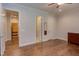 Spacious bedroom with hardwood floors, ceiling fan, and view into a walk-in closet at 1009 Margarets Ln, Raleigh, NC 27614