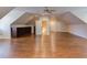 Spacious bonus room with wood floors, built-in bookshelves, and many windows to provide natural light at 1009 Margarets Ln, Raleigh, NC 27614