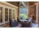 Charming covered stone patio featuring comfortable seating and a stone fireplace at 1009 Margarets Ln, Raleigh, NC 27614