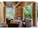Lovely covered patio with a stone fireplace, ceiling fan, and beautiful outdoor seating at 1009 Margarets Ln, Raleigh, NC 27614