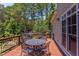 Spacious wooden deck features outdoor seating, mature trees, and views of the pond at 1009 Margarets Ln, Raleigh, NC 27614