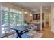 Bright dining area features a modern chandelier, large windows, and access to the outdoor deck at 1009 Margarets Ln, Raleigh, NC 27614