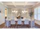 Bright dining room with modern chandelier, white wainscoting, and neutral color palette at 1009 Margarets Ln, Raleigh, NC 27614