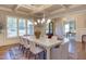 Dining room with coffered ceilings, chandeliers, and large windows for natural light at 1009 Margarets Ln, Raleigh, NC 27614