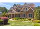 Beautiful stone home with manicured lawn and landscaping, showcasing curb appeal at 1009 Margarets Ln, Raleigh, NC 27614