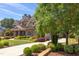 Charming stone home with lush front yard, landscaping, and long drive way at 1009 Margarets Ln, Raleigh, NC 27614