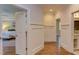 Hallway that leads to the Main Bedroom featuring white walls and wood floors at 1009 Margarets Ln, Raleigh, NC 27614