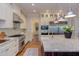 Open kitchen with stainless steel appliances, custom cabinets, and access to the dining area at 1009 Margarets Ln, Raleigh, NC 27614