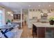Spacious kitchen with white and wood cabinets, marble countertops, stainless appliances, and hardwood floors at 1009 Margarets Ln, Raleigh, NC 27614
