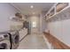 Spacious laundry room features tile flooring, washer, dryer, and custom storage and bench at 1009 Margarets Ln, Raleigh, NC 27614