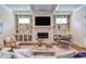 Bright living room featuring a fireplace, built-in shelves, and hardwood flooring at 1009 Margarets Ln, Raleigh, NC 27614