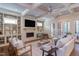 Cozy living room with a fireplace, built-in bookshelves, and coffered ceilings at 1009 Margarets Ln, Raleigh, NC 27614