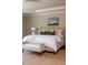Relaxing main bedroom features a neutral color palette, decorative pillows, and tray ceilings at 1009 Margarets Ln, Raleigh, NC 27614