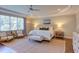 Spacious Main Bedroom boasts a ceiling fan, sitting area, and large window with natural light at 1009 Margarets Ln, Raleigh, NC 27614