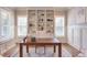 Well-lit office with built-in bookshelves, window seating, and area rug at 1009 Margarets Ln, Raleigh, NC 27614