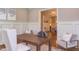 Elegant office features a wooden desk, stylish chairs, wainscoting, and soft gray walls at 1009 Margarets Ln, Raleigh, NC 27614
