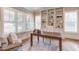 Sunlit office space with built-in shelves, window bench, and area rug at 1009 Margarets Ln, Raleigh, NC 27614