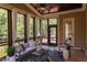 Relaxing screened porch with fireplace, ceiling fan and views of the surrounding greenery at 1009 Margarets Ln, Raleigh, NC 27614