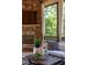 Close-up of screened in porch featuring a stone fireplace, stylish seating, and outdoor views at 1009 Margarets Ln, Raleigh, NC 27614