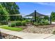 Outdoor community space with shaded seating areas, barbecue grills, and landscaped surroundings for residents at 105 Chatham Walk Ln # 304, Cary, NC 27511