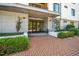 Elegant building entrance with brick pathway and manicured landscaping at 105 Chatham Walk Ln # 304, Cary, NC 27511