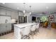 Open kitchen concept with bar seating, stainless steel appliances, and view to living room at 105 Chatham Walk Ln # 304, Cary, NC 27511