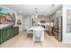 Stylish kitchen featuring stainless steel appliances, gray cabinets, and a large central island with seating at 105 Chatham Walk Ln # 304, Cary, NC 27511