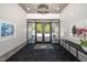 Welcoming lobby with black tile, modern lighting, and glass door access to outside at 105 Chatham Walk Ln # 304, Cary, NC 27511