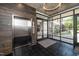 Modern lobby area featuring an elevator, wood accent wall, and glass exterior at 105 Chatham Walk Ln # 304, Cary, NC 27511