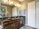 Bathroom with double vanity and a full mirror at 108 S Drawbridge Ln, Cary, NC 27513