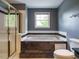 Bathroom with a large white tub and walk in shower with gold accents at 108 S Drawbridge Ln, Cary, NC 27513