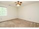 Bedroom with neutral walls, carpet, ceiling fan, and a window letting in natural light at 108 S Drawbridge Ln, Cary, NC 27513