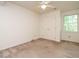 Bedroom with neutral walls, white trim, ceiling fan, and closet at 108 S Drawbridge Ln, Cary, NC 27513