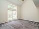 Spacious bedroom featuring plush carpeting, high ceilings and a large window at 108 S Drawbridge Ln, Cary, NC 27513