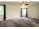 Spacious bedroom with a ceiling fan, large windows, and neutral walls at 108 S Drawbridge Ln, Cary, NC 27513