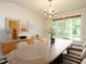 Dining room with modern chandelier and large window view at 108 S Drawbridge Ln, Cary, NC 27513