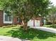 Charming two-story brick home with a well-manicured lawn, mature trees and a two-car garage at 108 S Drawbridge Ln, Cary, NC 27513