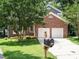 Charming two-story brick home with a well-manicured lawn, mature trees and a two-car garage at 108 S Drawbridge Ln, Cary, NC 27513