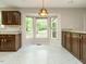 Kitchen with dark wood cabinets and bay window at 108 S Drawbridge Ln, Cary, NC 27513