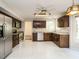 Open kitchen featuring stainless appliances and tile flooring at 108 S Drawbridge Ln, Cary, NC 27513