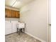 A functional laundry room with overhead storage and a utility sink at 108 S Drawbridge Ln, Cary, NC 27513