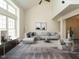 Bright living room with neutral walls, modern furniture, and large windows at 108 S Drawbridge Ln, Cary, NC 27513