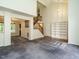 Spacious living room featuring an open staircase, built-in bookshelf, and hardwood floors at 108 S Drawbridge Ln, Cary, NC 27513