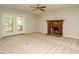 Living room with fireplace and ceiling fan with access to the covered deck at 108 S Drawbridge Ln, Cary, NC 27513