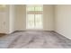 Spacious living room with large windows allowing for ample natural light at 108 S Drawbridge Ln, Cary, NC 27513
