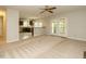 Open floor plan living room with eat in kitchen, stainless steel appliances, and backyard access at 108 S Drawbridge Ln, Cary, NC 27513