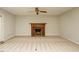 Living room features a brick fireplace, neutral carpet, and natural lighting at 108 S Drawbridge Ln, Cary, NC 27513